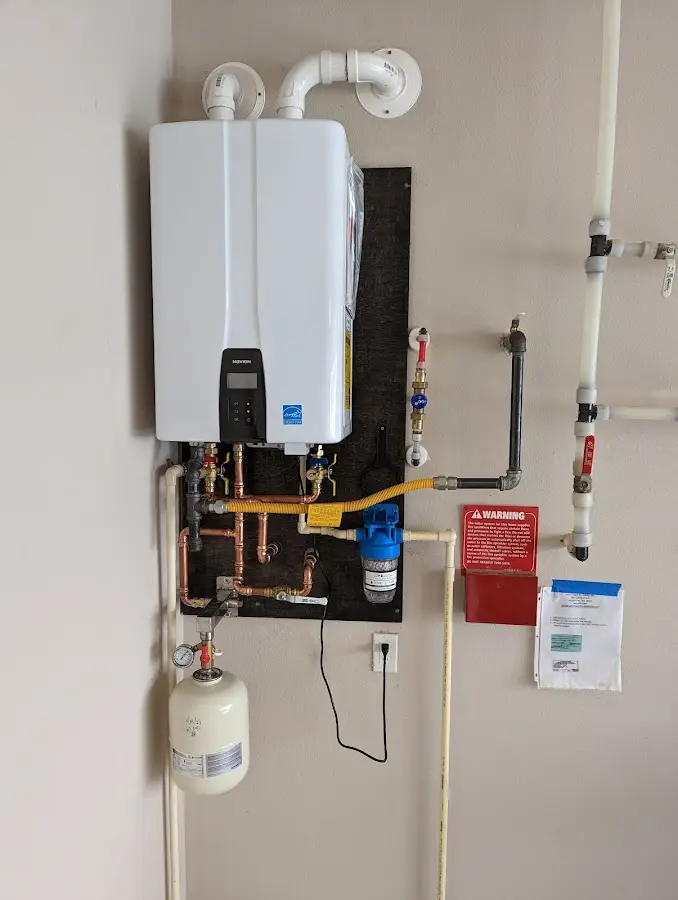 Professional plumber installing copper piping in a Friendship Heights Village home